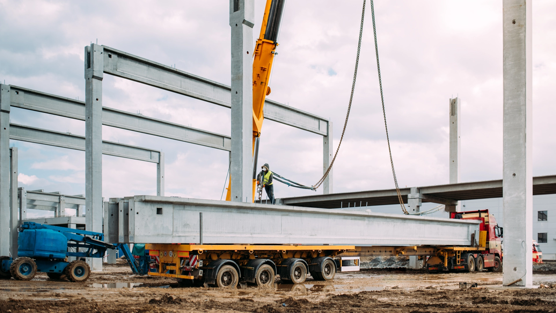Crew using crane to install concrete beams during precast structures erection across the United States and Puerto Rico
