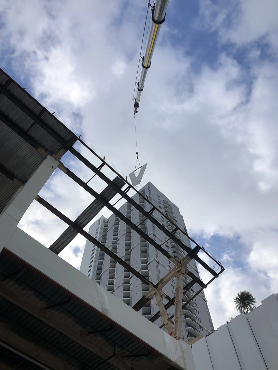 Crane lifting structural components for high-rise project by Concrete Erectors, Inc