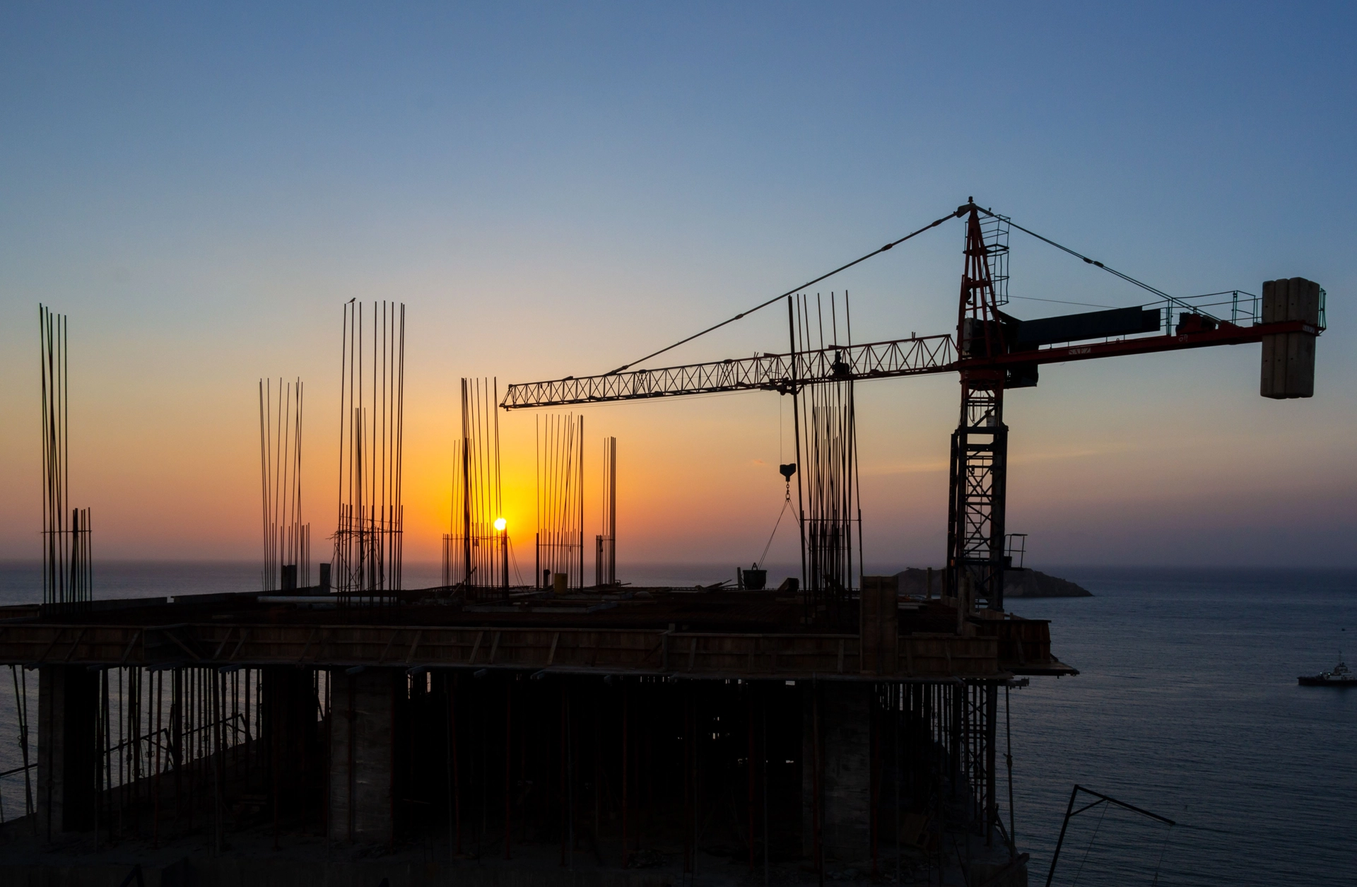 Precast erectors at Concrete Erectors, Inc. installing concrete structure with crane at job site in the United States
